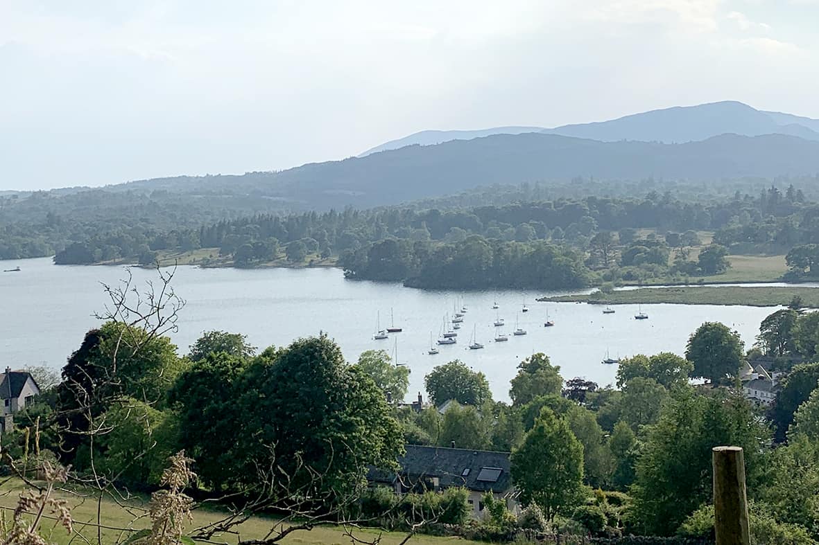 Lake Windermere with boats and mountains in the background